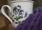 Dark volet scarf and and a cup with vilolet flowers.