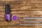 On a dark wooden background, manicure items, purple rhinestones for nails, nail Polish and brushes for easy application, close-up
