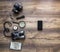On a dark wooden background passport map camera magnifier lantern compass binoculars phone smartphone trip vacation