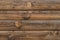 Dark wooden fence. Shabby table, dirty pine lumber. Old wood boards. Pattern, surface of logs. Backgrounds of cracked planks, bar.