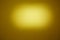 On a dark yellow background, an oval yellow cloud of light