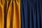 Dark yellow and blue draped curtains.Empty space for design