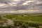 Darkened spring sky over the road leading to the medieval monastery of Khor Virap among gardens and vineyards on the background of