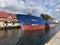 Darlowko, Poland: Cargo ship leaving the port on a summer day