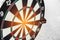 Dart board and arrow in middle. Business and success concept. Achievement and target theme. Orange sun light effect. High contrast