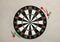 Dart board with color arrows on light stone background