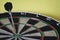 Dart on bulls eye target of dartboard, concept of victory and goal achievement, selective focus