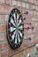 Dart in bullseye on the target with many other Darts