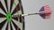 Dart featuring flag of the USA hits bullseye of the target. Sports or political success related conceptual animation