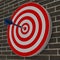 Dart hitting center target on dartboard