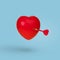 Dart  hitting in a red heart, isolated on a blue background