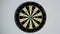 Dart strikes the bulls-eye of a dartboard