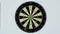 Dart strikes the bulls-eye of a dartboard