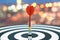 Dart target arrow on bullseye over blurred bokeh background