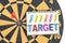 Dart target in bullseye with words target on the notebook with h