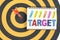 Dart target in bullseye with words target on the notebook with h