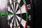 Dartboard with arrows on a black background.Darts game.Successful game.National English game.Target.