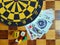 Dartboard with cards and dice on chessboard