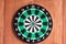 Dartboard hanging on wooden wall