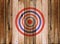 Dartboard target on old wooden wall