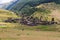 Dartlo village view with houses and people in the fields forested mountains in the background