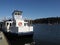 The Dartmouth ferry docked at the quayside in Dartmouth with sun and blue sky