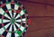 Darts over wooden background. Arrows missed target