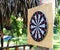 Darts on a wooden frame in the garden. games on fresh air