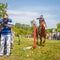 A dashing Cossack knocks down the sword of a bottle of water on a horse