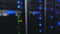 Data center, server room in a blurry background. Blinking blue led ligts