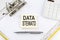 DATA STEWARD - business concept, message on the sticker on folder background with calculator