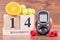 Date of 14 November, glucose meter and ripe fruits, world diabetes day concept