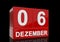 The date of 6 Dezember in white numbers and letters on red, glossy blocks