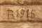 Date inscription carved into sandstone block