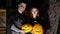 Date in style of Halloween party, night, twilight, in the rays of light, guy with a girl dressed in costumes and with a