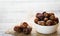 Dates fruit on dark wooden background. Muslim simple Iftar concept. Ramadan food and drinks