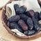 Dates fruit or kurma in bamboo basket.