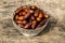 Dates fruit on silver bowl on wooden table. The Muslim feast of the holy month of Ramadan Kareem