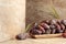 Dates fruit in a wooden dish on a beige ceramic table
