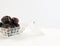 Dates in glass container over white. High in natural sugar packed with plenty of nutrients. Conceptual of breaking fast in