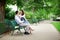 Dating couple hugging on a bench in a Parisian park