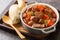 Daube de Boeuf Provencale slow cooked Rich Beef Stew closeup in the wooden tray. Horizontal