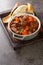 Daube Provencal French stew beef with vegetables is slow simmered to tenderness closeup in the wooden tray. Vertical