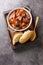 Daube Provencal French stew beef with vegetables is slow simmered to tenderness closeup in the wooden tray. Vertical top view