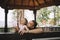 Daughter and father having fun in wooden gazebo