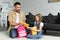 daughter and father packing backpack for first day at school back to