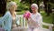 Daughter with flowers and gift for senior mother