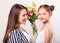 Daughter gives flowers to her mother on her mother`s day