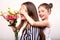 Daughter gives her mother flowers in the studio, happy mother`s