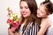 Daughter gives her mother flowers in the studio, happy mother`s